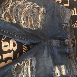 Blue jeans with rips and chains